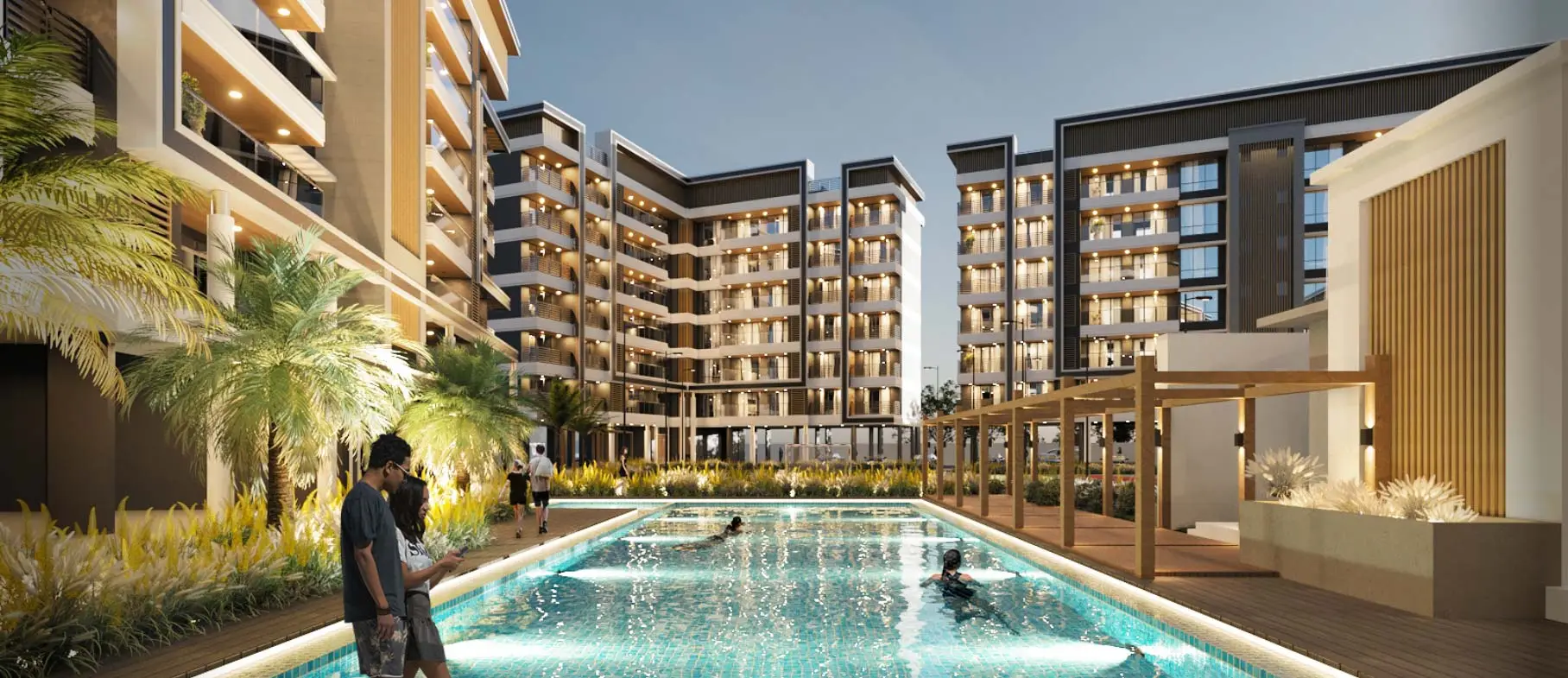 A pool surrounded by a large apartment building, Nyati Elite, offering 3 & 4.5 BHK premium flats