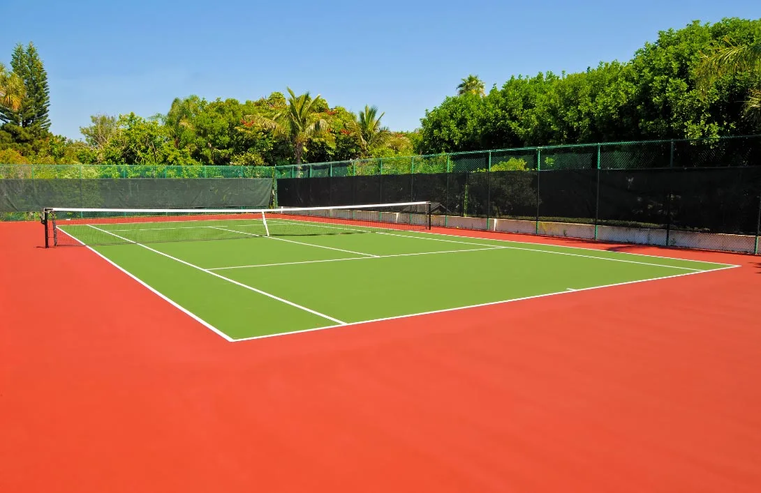 Tennis court with green and red surface at Nyati-Elite, Premium flats.