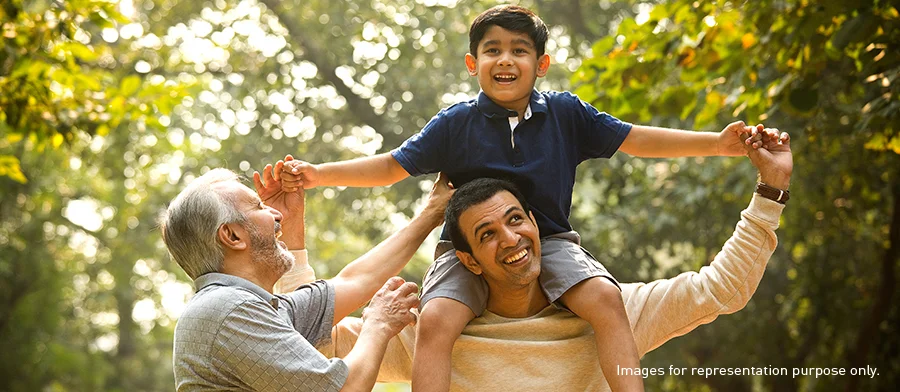 A joyful moment in the park with three generations, featuring a grandfather, father, and young son, surrounded by lush greenery.​